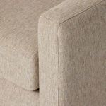 Detailed close-up of armrest corner stitching and thick upholstery fabric