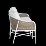 Side profile of sofa showing curved armrest and cane panel with white frame