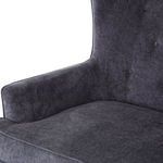Close-up showing tufted backrest and padded charcoal velvet armrest corner