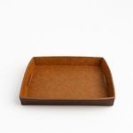 Side view showing the height and stitched leather handles on the brown tray