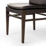 Close-up of front leg and corner joint construction with leather trim on Aya Sonoma chair