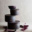 Stacked Hazel Serving Bowls arranged artistically with purple cabbage leaves on neutral backdrop