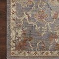 Close-up of the rug corner on dark wood flooring highlighting the fringe and intricate multi-color pattern.