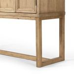 Close-up of elevated stand's squared wooden legs and horizontal base support.