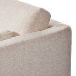 Partial side view of Toland sectional armrest and loose cushions in cream basketweave fabric