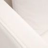Close-up showing the tight woven texture and double stitching of the slipcover fabric on the armrest