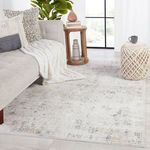 Vida Abstract rug styled in softly lit living room with light gray sofa and knitted throw
