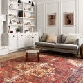 Loren rug styled in living room with gray sofa, woven stool, and white built-in shelves