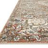 Close-up of Saban rug corner showing low pile and detailed border pattern with beige, red, blue, and olive hues