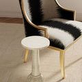 Osa Drinks Table styled in an elegant living room next to a striped black and white armchair