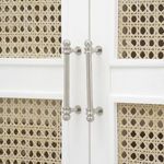 Close-up of polished nickel door pulls with ball finials on white lacquered and cane panel doors