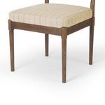 Close-up of cushioned seat and brown oak frame corner showing wood grain and fabric texture
