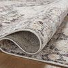Monroe rug folded to show pile texture and flexibility with neutral pattern hues