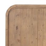 Close-up showing texture and wood grain of curved headboard with nail holes and knots