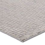 Close-up angled view showing high-low pile texture and color variation of geometric pattern