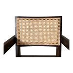Close-up of Takashi chair’s rattan back weaving pattern and dark wood frame edges