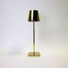 Vera Gold Poldina Pro Table Lamp viewed slightly from the left side showing slight shadow on background
