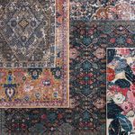 top-down view of multiple rugs layered showing color and pattern contrasts with Azura in pink and gold