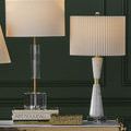 Several table lamps including Edelmar with pleated shades styled on tall gilt-legged console