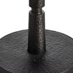 Close-up showing textured black metal base cylindrical section connecting to round base
