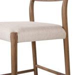 Close-up of the cushioned seat and upper support bars along the smoked oak legs