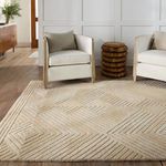 Rug in sitting room with two white armchairs and woven stool on wooden floor against paneled wall
