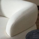 Macro shot of fabric texture on sofa armrest showcasing soft woven fibers