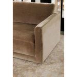 Close view of sofa armrest fabric transitioning from brown to lighter beige tone