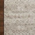 Close-up of ivory rug’s textured geometric pattern showing fine handwoven yarns and natural color variations