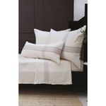 Closer angled view of Geneva Blanket and pillows highlighting broad plaid weave and soft texture