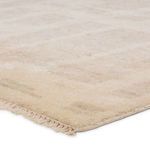 Close-up of soft pile texture and short cream fringe on rug corner