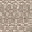 Close-up of the tan rug showing detailed woven texture and subtle pattern variations