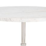 Close-up of white marble tabletop showing natural veining and polished edge
