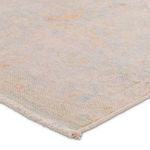 Close-up of rug corner showing soft woven texture and subtle vintage distress effect