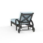 Rear view of Monterey Chaise Lounge showing cross back detail and wheels beneath curled arms