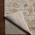 Back of Milena Sage / Multi rug turned up showing beige woven backing with subtle color pattern
