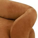 Close-up of sofa arm curved upward framing the open back cutout with stitched seams