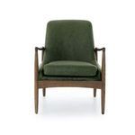 Side perspective showing sleek silhouette of oak frame supporting leather upholstery