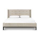 Full front view of upholstered king bed with tufted headboard and metal base on white background