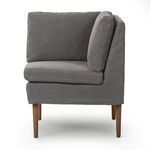 Side angle of banquette revealing profile of thick seat and back cushions with subtle skirt around base