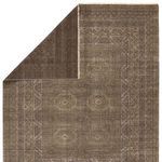 Back side of rug folded over revealing solid darker brown backside and finished edges
