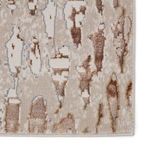 Close-up of rug edge highlighting the intricate weave and color variations in bronze and beige tones