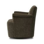 Side profile of Camellia Swivel Chair highlighting arm thickness and swivel base.