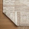 Corner fold of Rivers Lilac / Ivory Rug revealing dense weave and fringe on hardwood floor
