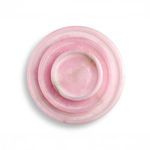 Top view of three pink alabaster trays stacked with visible white and brown stone veining