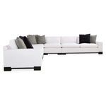 Front perspective of large Refresh sectional with mixed gray and black pillows on white cushions