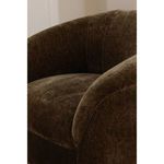 Close-up of dark brown velvet upholstery highlighting soft texture and plush rolled arm detail