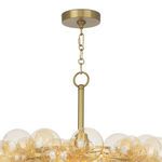 Close-up of the chandelier’s brass canopy and chain with attached metal rod
