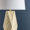 Close-up side view showing aged brass neck detail and the lamp's angular triangular cut pattern on base