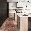 Long, narrow runner version of the rug laid out in a modern kitchen with light wood cabinets and dark accents